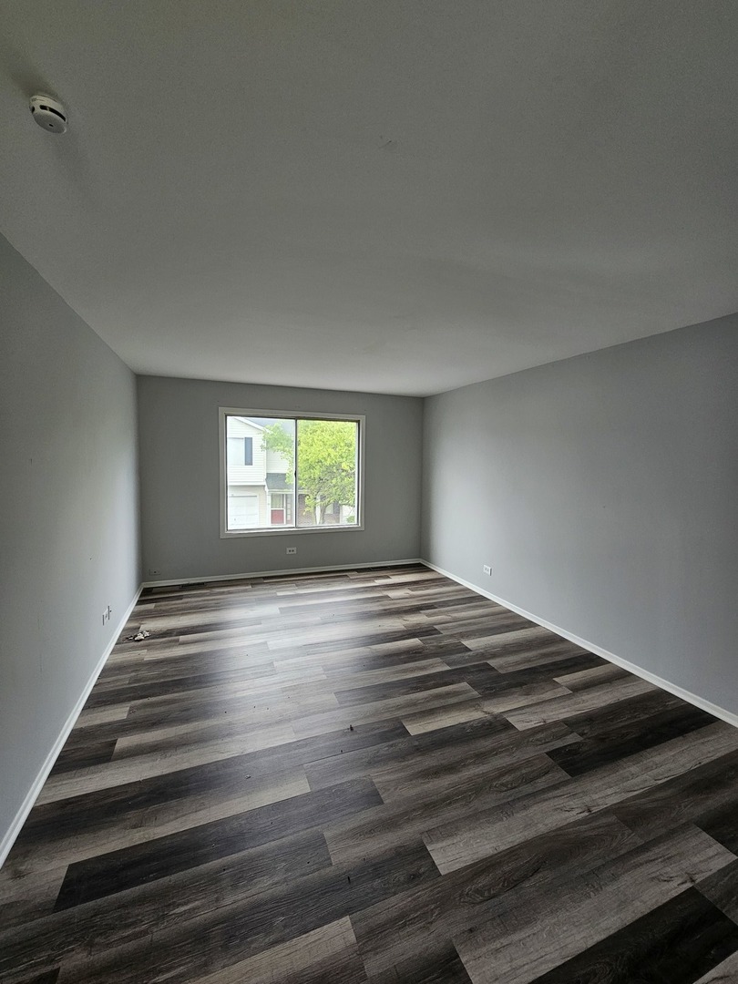 61 Red Barn Road, Unit 1 Matteson, IL 60443 - Photo 5 of 13 a view of an empty room and window