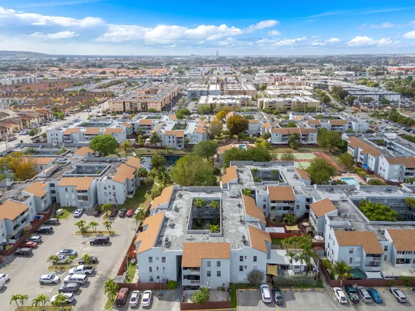 an aerial view of residential houses with city view