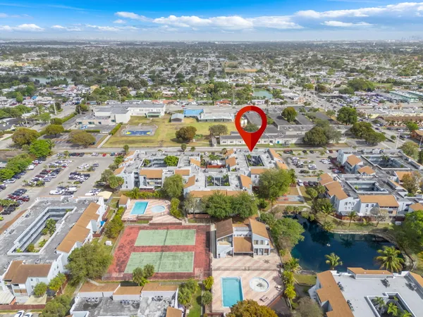 an aerial view of residential houses with outdoor space