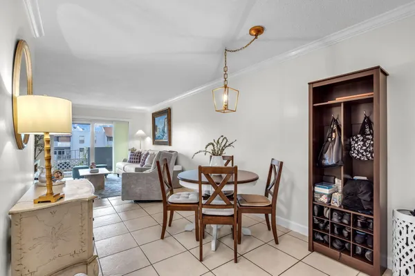a dining room with furniture and a chandelier