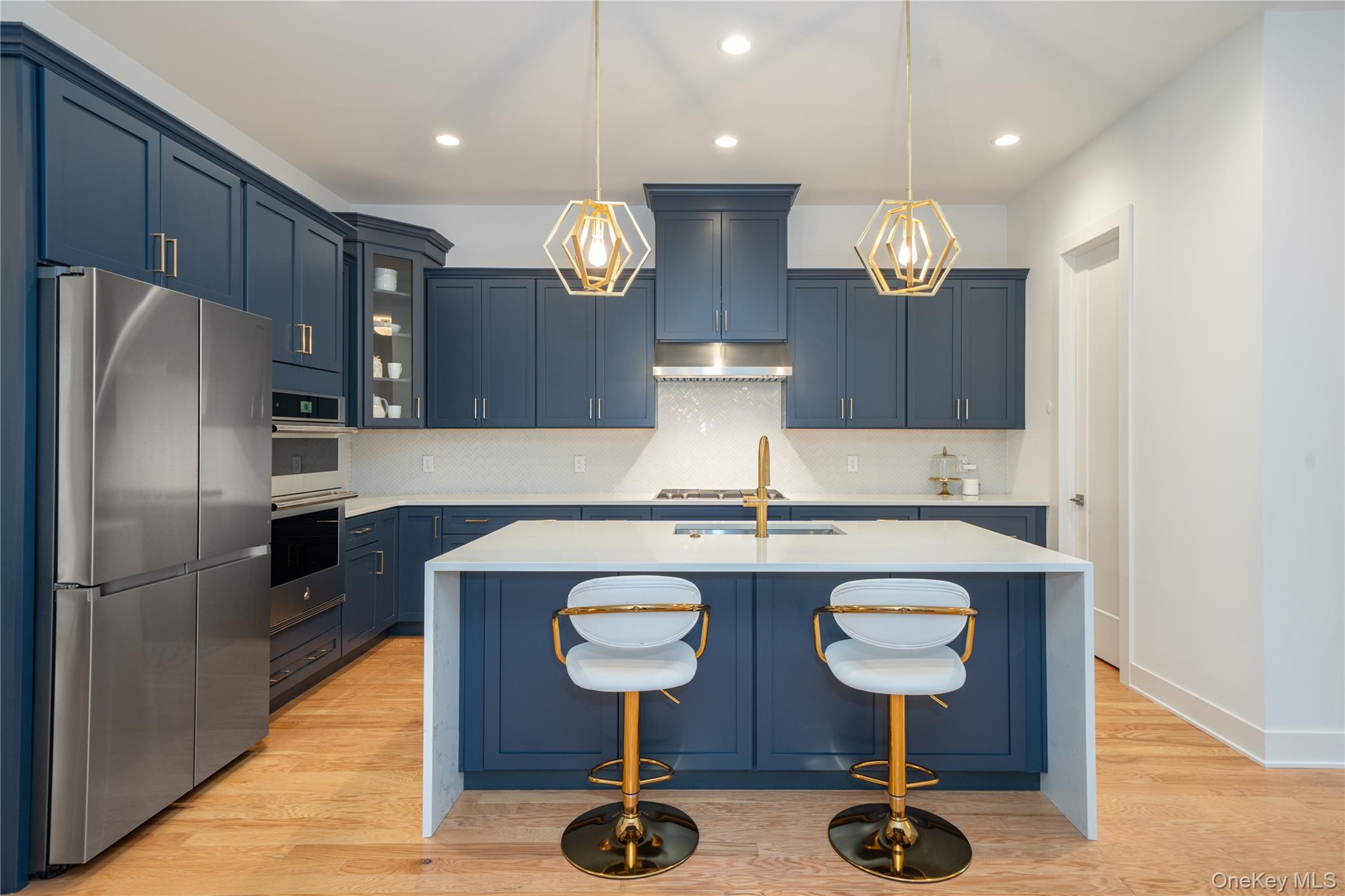 4 Wright Drive Chappaqua, NY 10514 - Photo 5 of 35 A stunning chef's kitchen featuring custom cabinetry, premium appliances, pantry, and a dramatic waterfall quartz island designed for gatherings and entertainment.