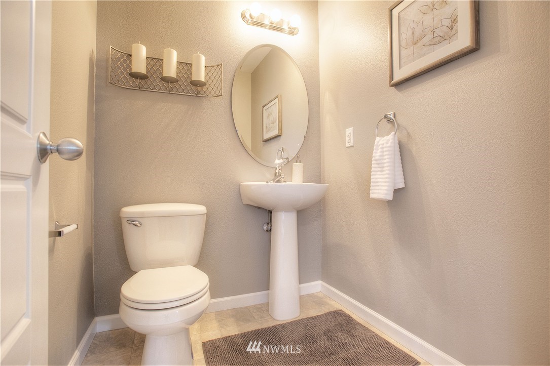 515 Harrison Street Sumner, WA 98390 - Photo 15 of 25 a bathroom with a sink mirror and toilet