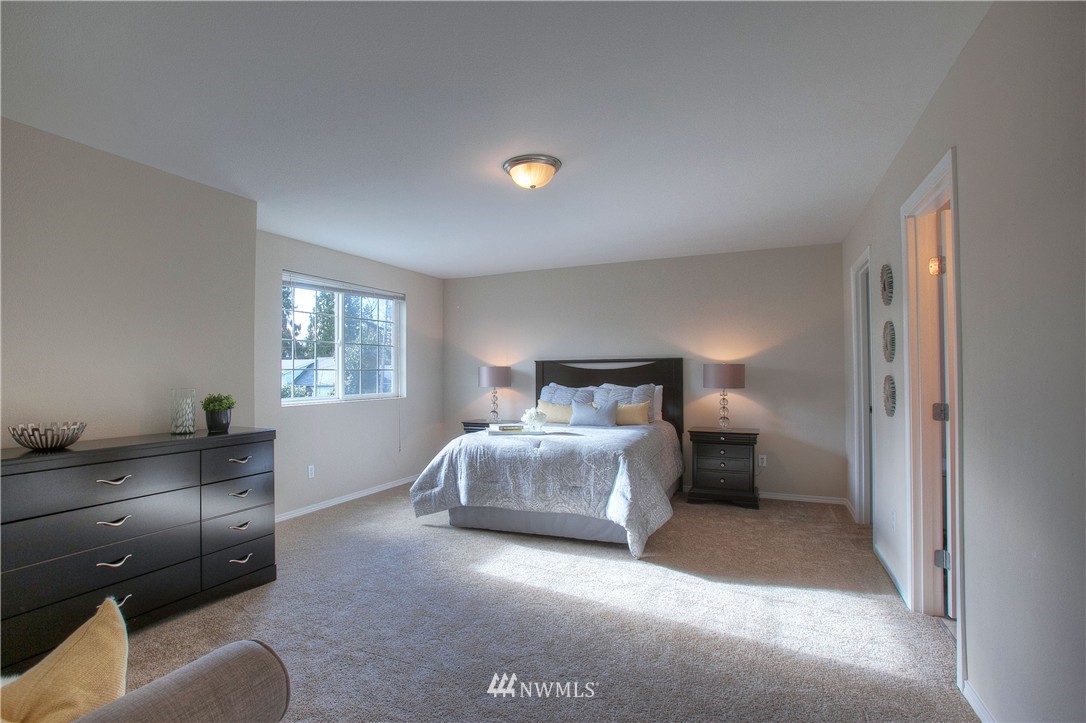 515 Harrison Street Sumner, WA 98390 - Photo 19 of 25 a spacious bedroom with a bed and window