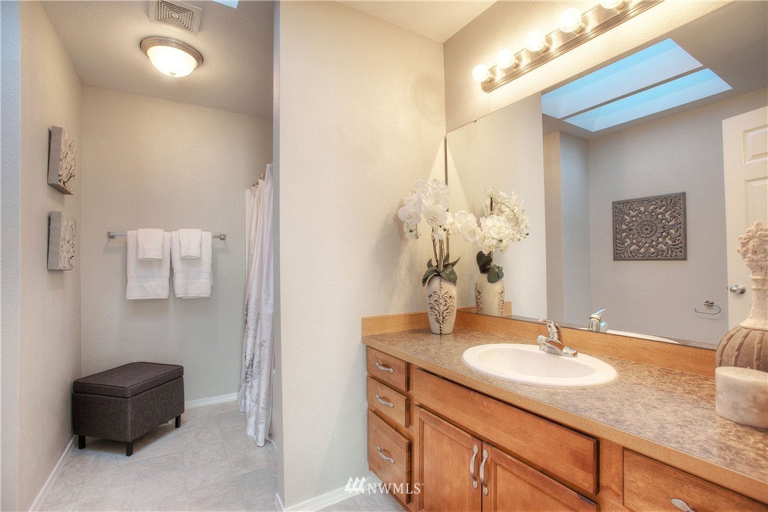 515 Harrison Street Sumner, WA 98390 - Photo 23 of 25 a bathroom with a granite countertop sink and a mirror