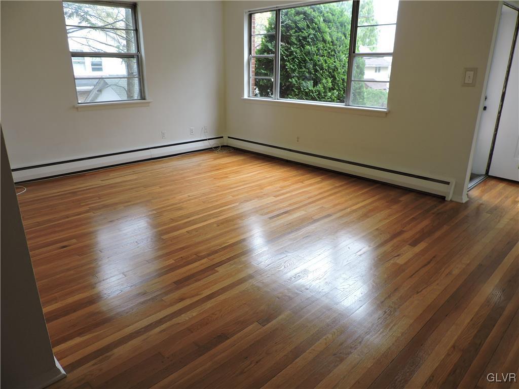 434 North Leh Street, Unit 1B Allentown, PA 18104 - Photo 2 of 7 an empty room with wooden floor and windows