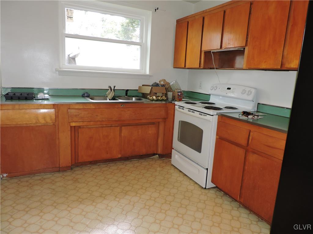 434 North Leh Street, Unit 1B Allentown, PA 18104 - Photo 3 of 7 a kitchen with stainless steel appliances granite countertop a stove a sink and a microwave