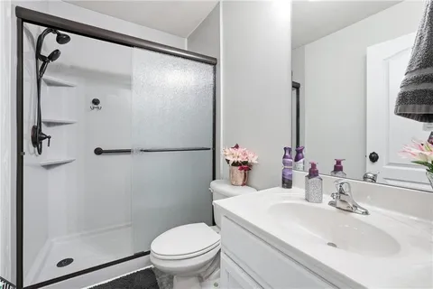 a bathroom with a sink toilet and shower