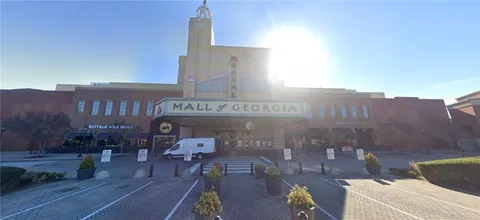 a front view of a building with outdoor seating