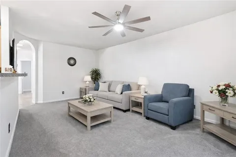 a living room with furniture and white walls