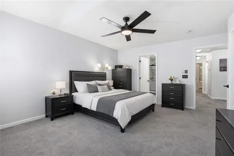 a bed room with a bed and a ceiling fan