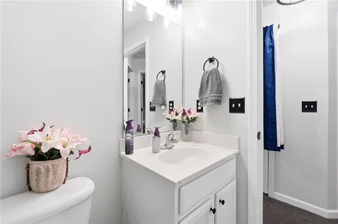 a bathroom with a sink vanity and a mirror