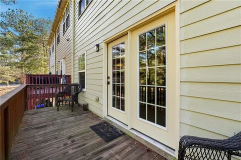 a view of a balcony with chairs and wooden floor