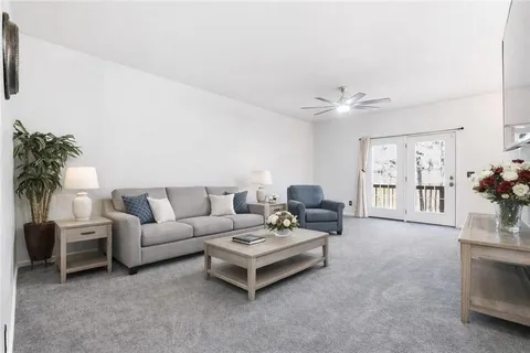 a living room with furniture and a large window