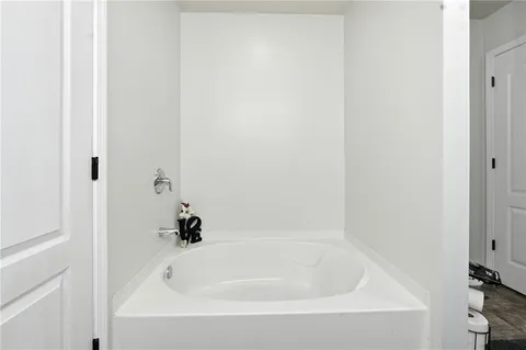 a white bath tub sitting next to a white sink