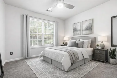 a bedroom with a large bed and a window