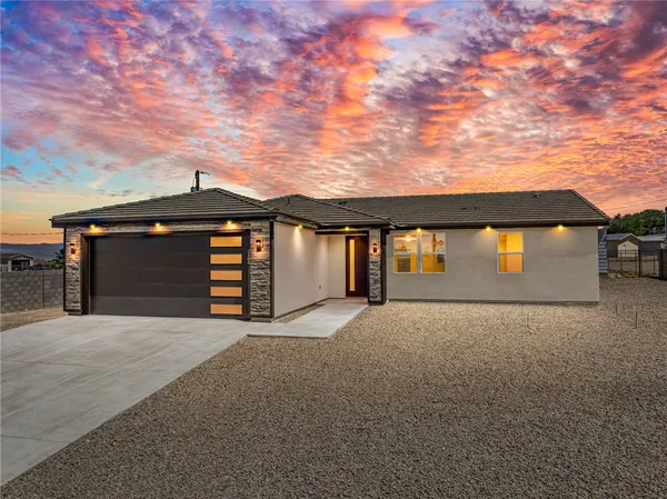 a view of an house with backyard of a house