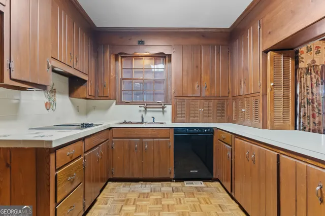 a kitchen with a sink stove and cabinets