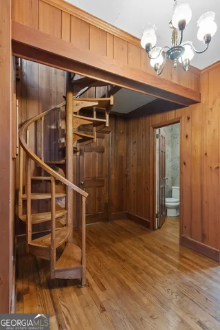 a bathroom with a granite countertop toilet a sink a mirror and a window