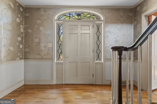 a view of an empty room with wooden floor