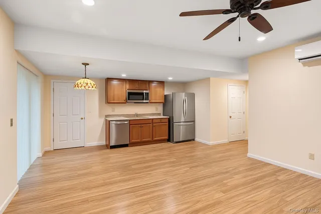 a kitchen with a refrigerator and a stove