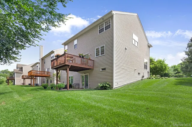a view of a house with a yard and deck