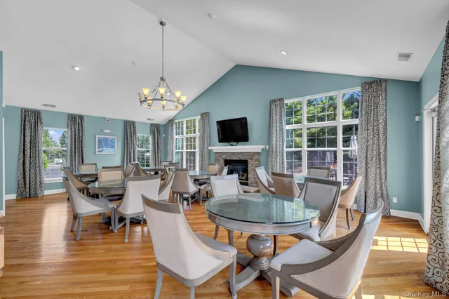 a dining room with furniture a fireplace and wooden floor