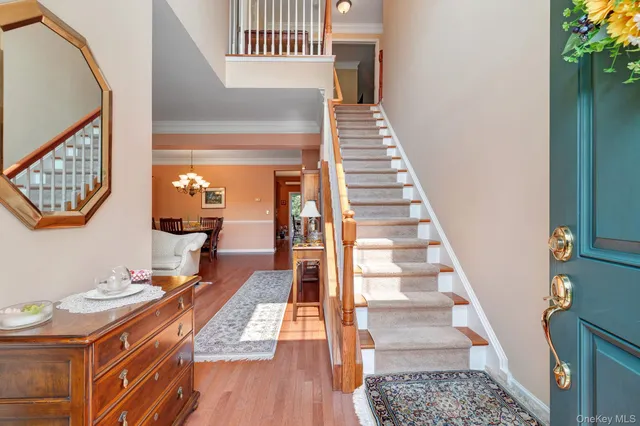 a view of entryway and hall with wooden floor