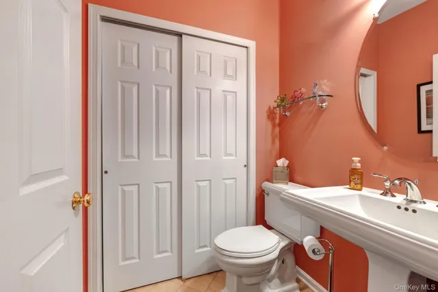 a bathroom with a sink a toilet and a mirror