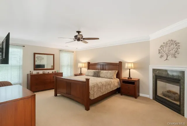 a spacious bedroom with a bed and a fireplace