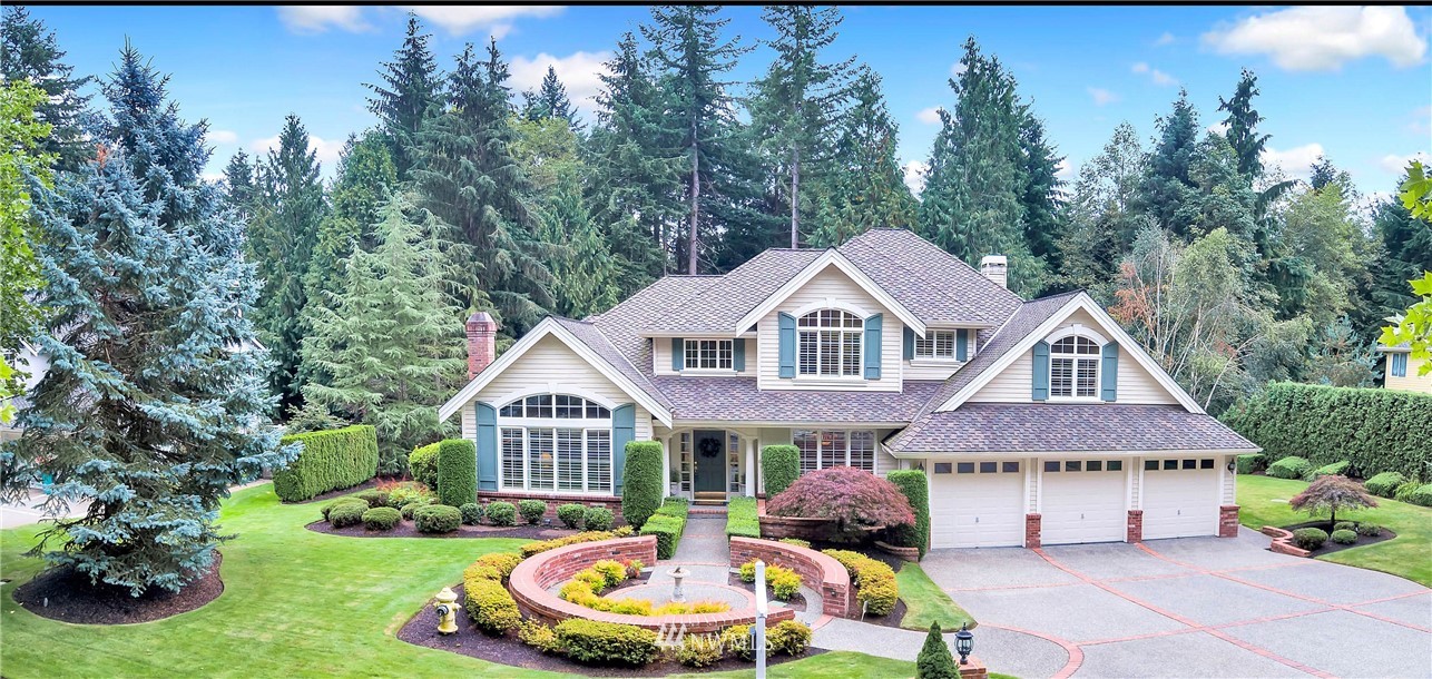 4916 177th Place Southeast Bothell, WA 98012 - Photo 1 of 25 a front view of a house with a garden and trees