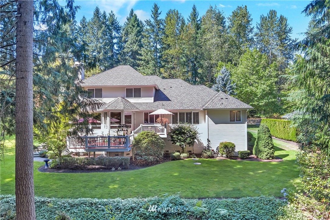 4916 177th Place Southeast Bothell, WA 98012 - Photo 2 of 25 a front view of a house with a yard and trees