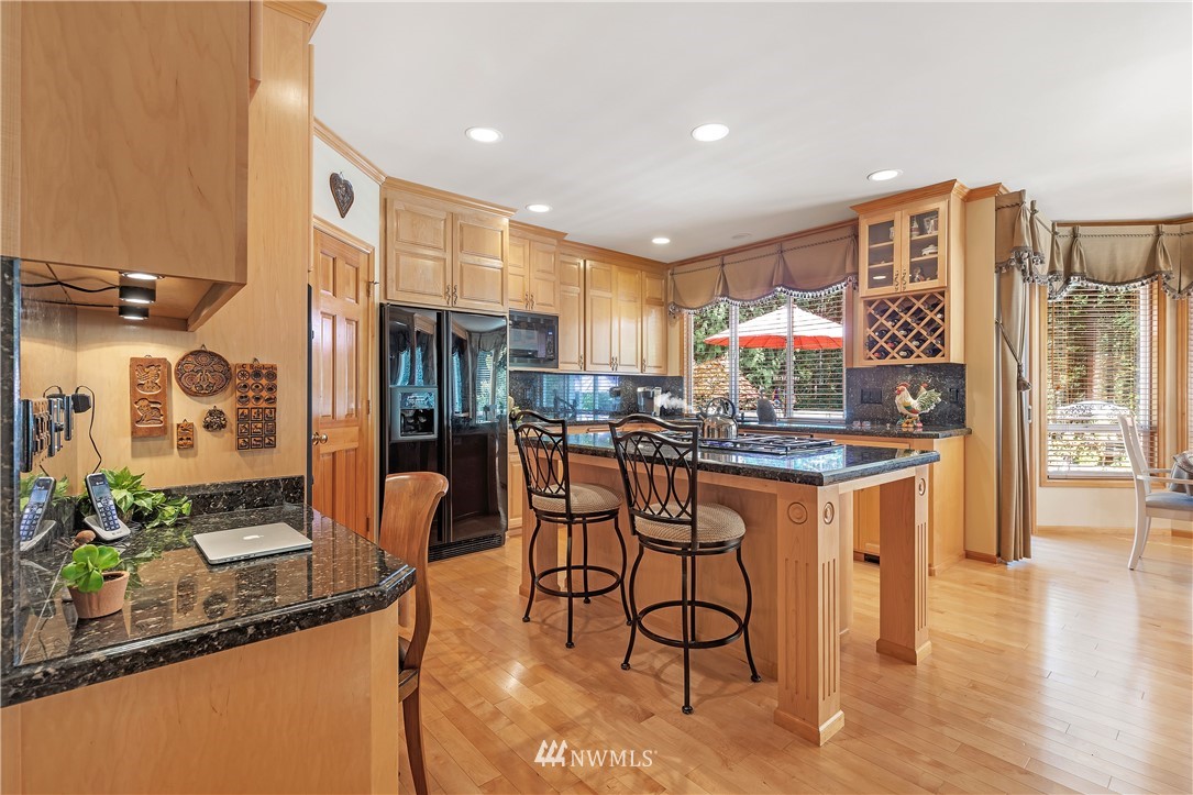 4916 177th Place Southeast Bothell, WA 98012 - Photo 12 of 25 a kitchen with stainless steel appliances granite countertop a stove a sink and a refrigerator