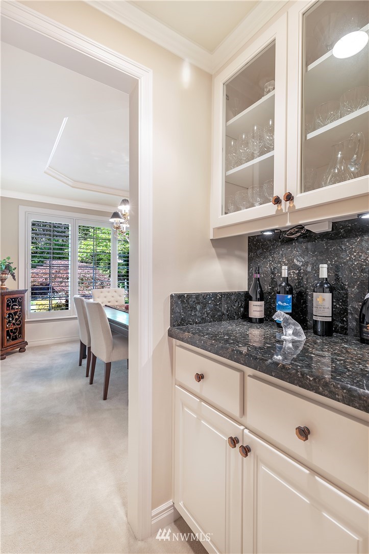 4916 177th Place Southeast Bothell, WA 98012 - Photo 14 of 25 a kitchen with granite countertop sink and cabinets
