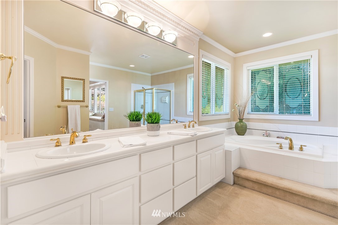 4916 177th Place Southeast Bothell, WA 98012 - Photo 17 of 25 a bathroom with double vanity sinks and a bathtub