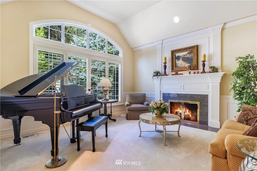 4916 177th Place Southeast Bothell, WA 98012 - Photo 6 of 25 a living room with furniture a fireplace and a large window