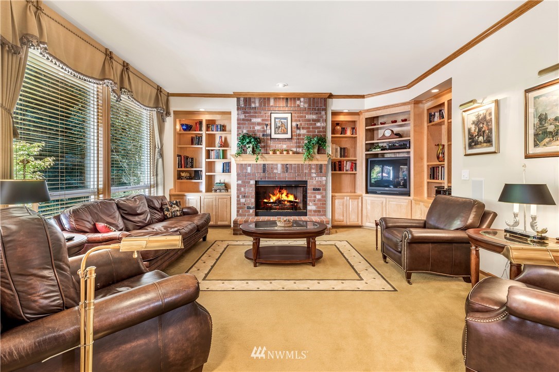 4916 177th Place Southeast Bothell, WA 98012 - Photo 9 of 25 a living room with furniture and a fireplace
