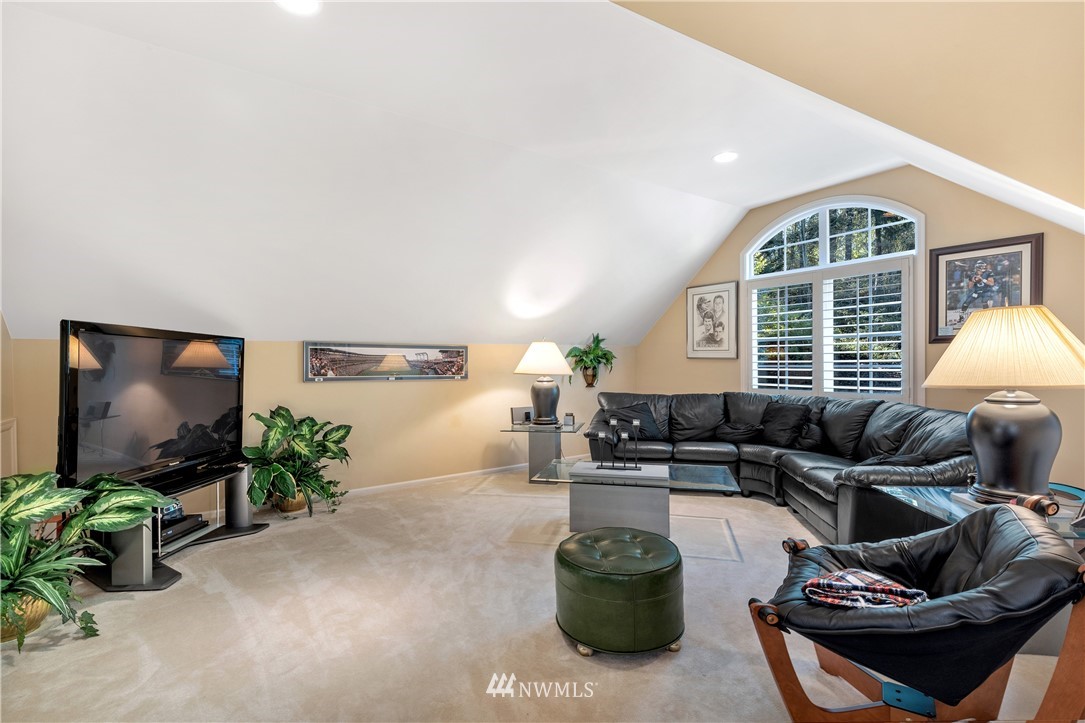 4916 177th Place Southeast Bothell, WA 98012 - Photo 10 of 25 a living room with furniture and a flat screen tv