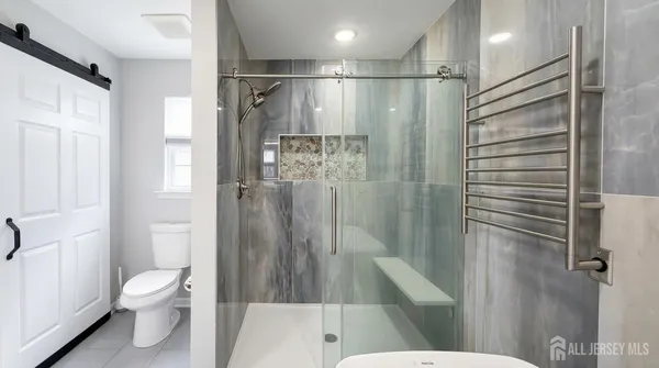 a bathroom with a shower and a toilet