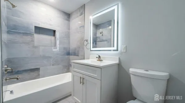 a bathroom with a sink a toilet and bathtub