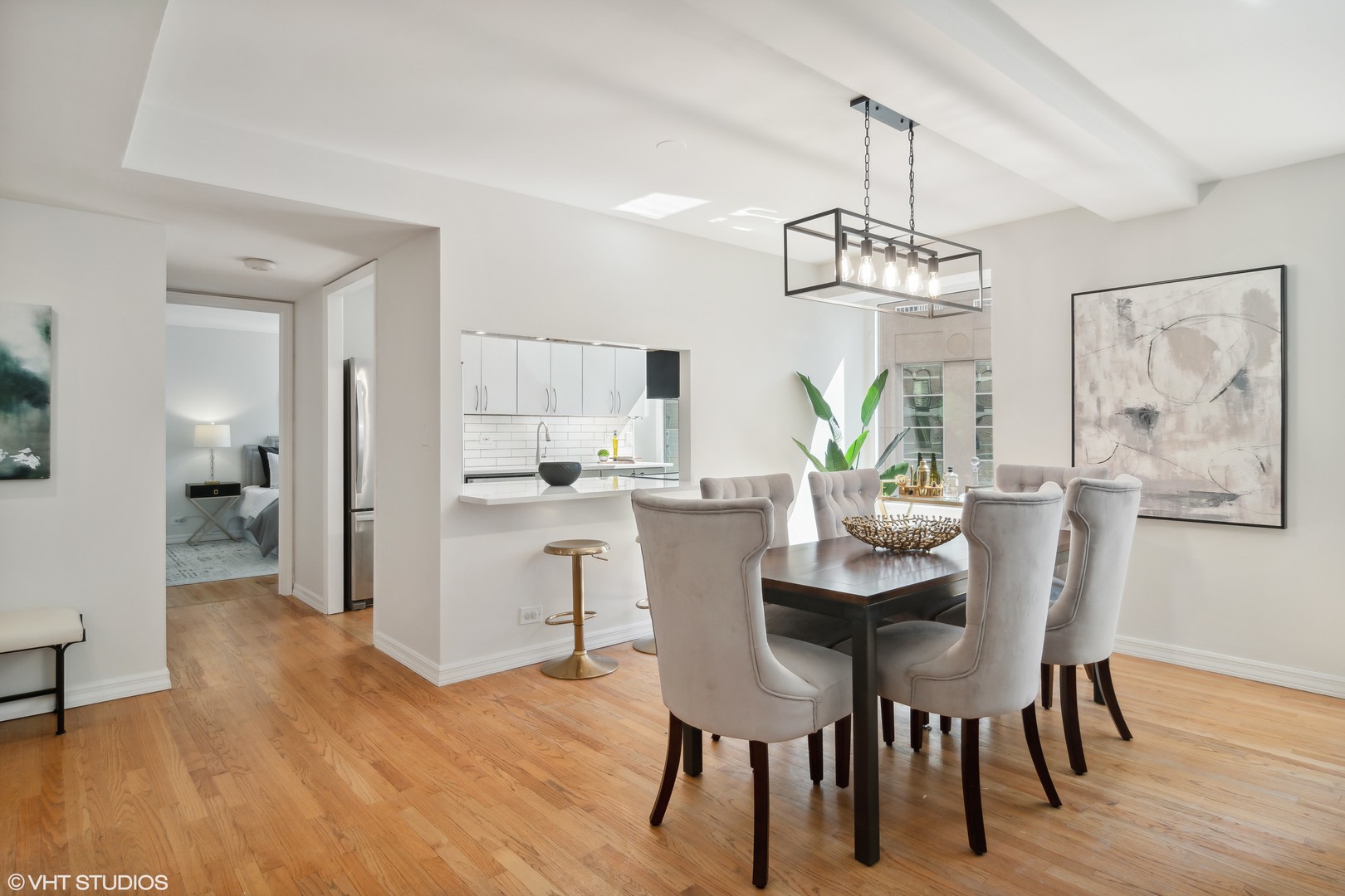 40 East Delaware Place, Unit 1602 Chicago, IL 60611 - Photo 11 of 27 a view of a dining room with furniture wooden floor and a chandelier