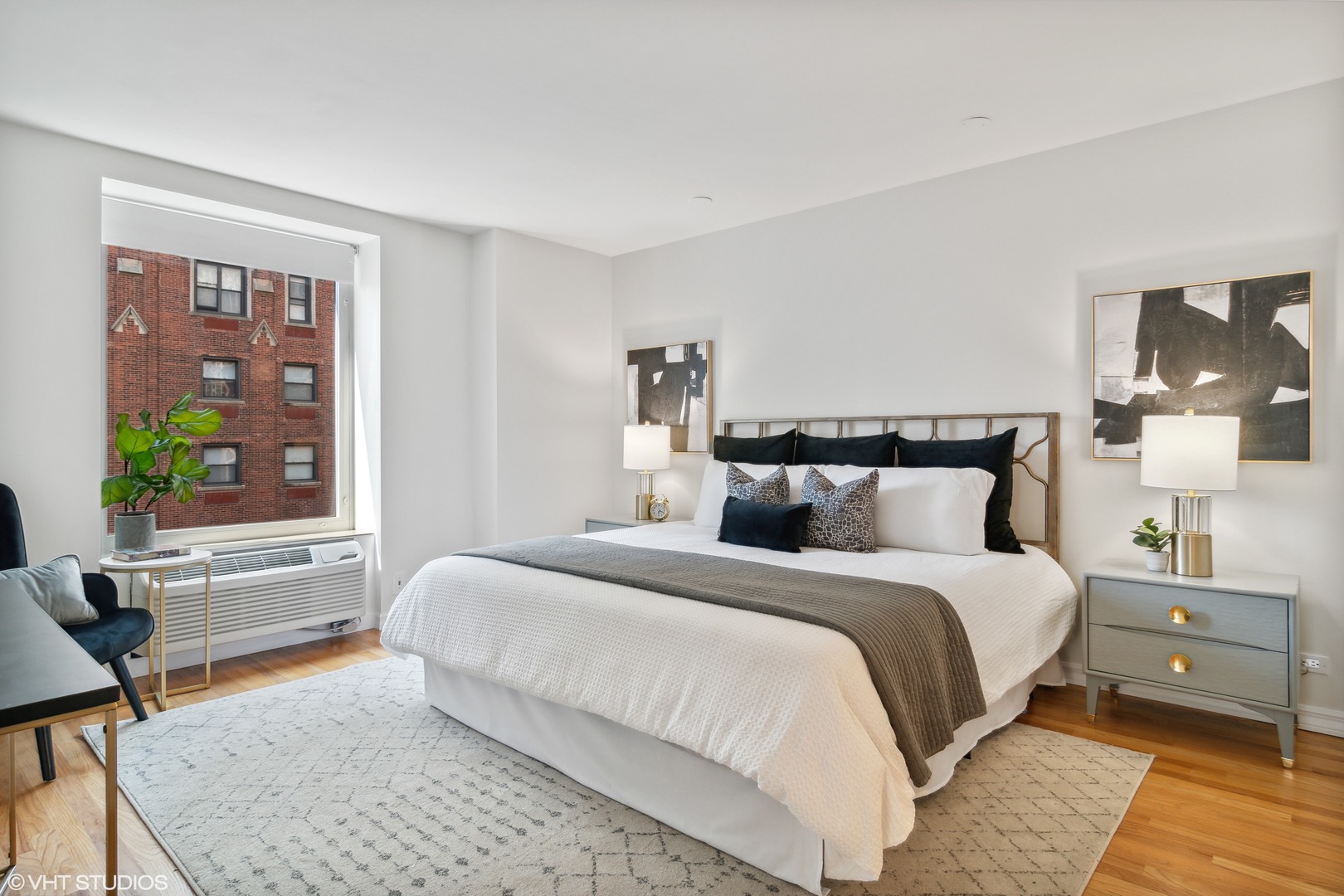 40 East Delaware Place, Unit 1602 Chicago, IL 60611 - Photo 13 of 27 a bedroom with a bed and wooden floor