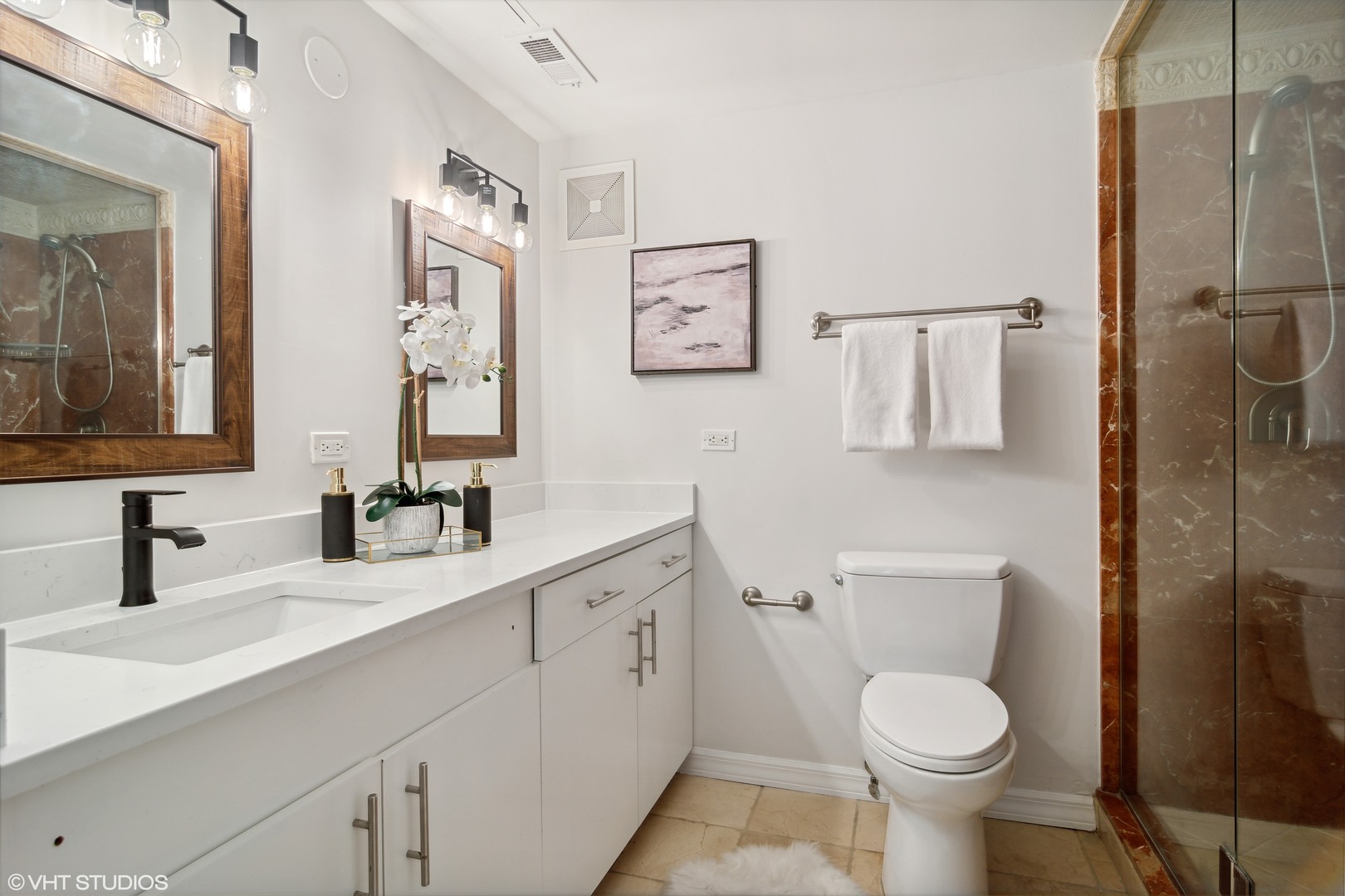 40 East Delaware Place, Unit 1602 Chicago, IL 60611 - Photo 15 of 27 a bathroom with a toilet sink and mirror