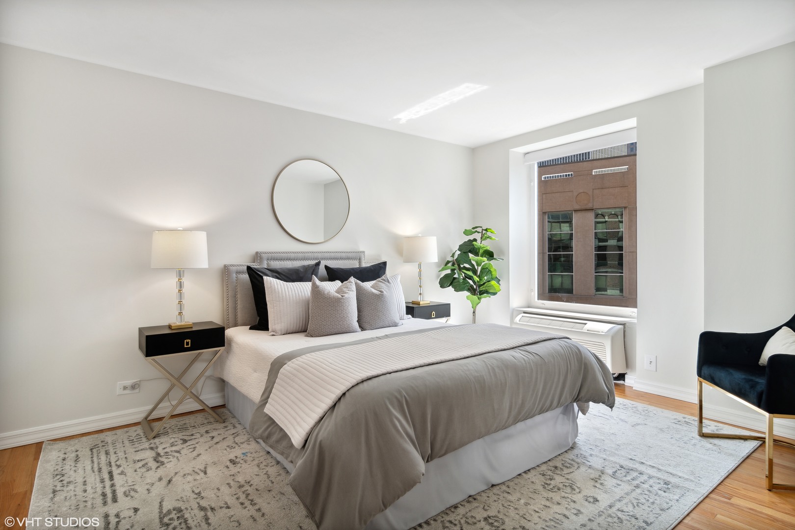40 East Delaware Place, Unit 1602 Chicago, IL 60611 - Photo 17 of 27 a bedroom with a bed lamp and a potted plant