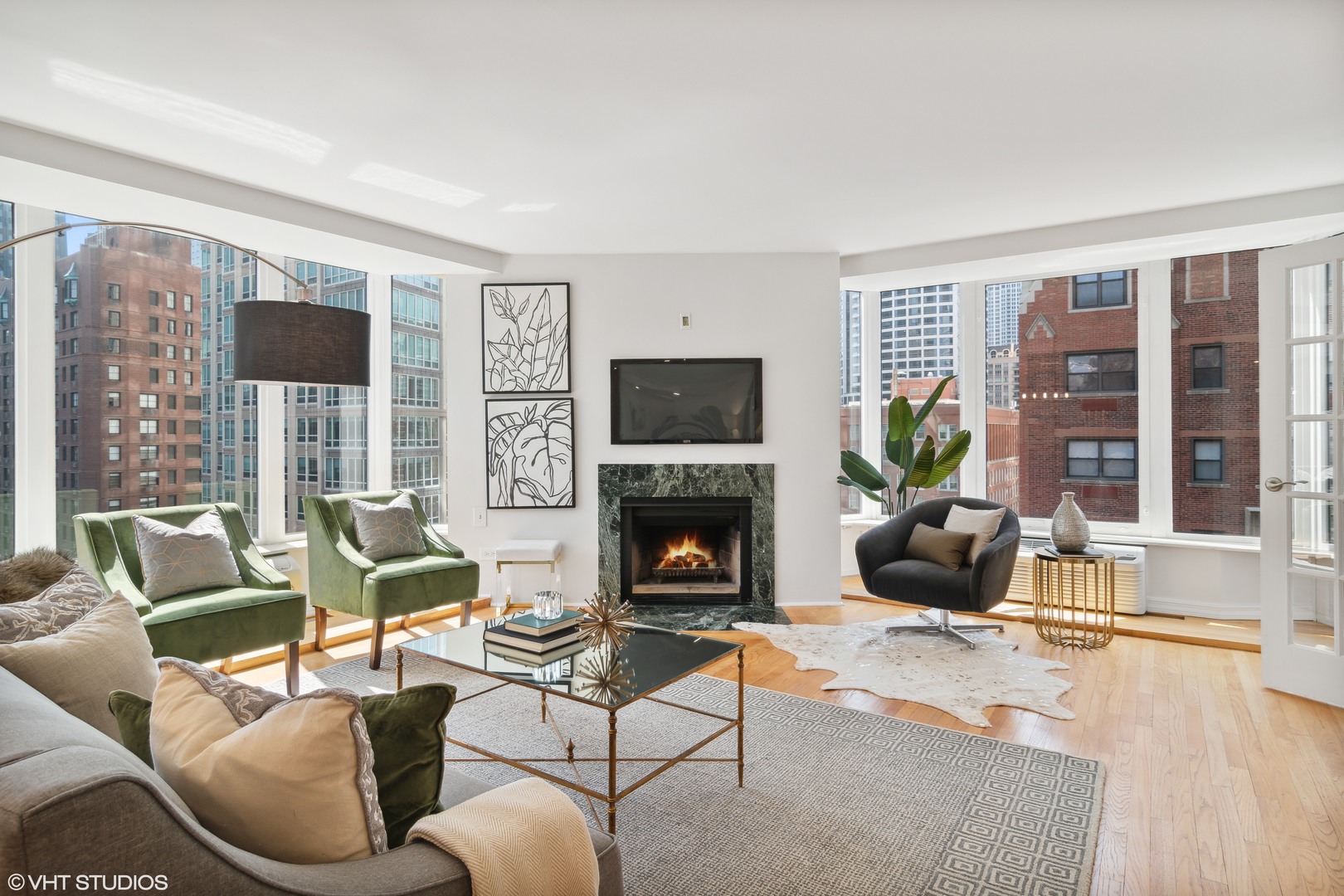 40 East Delaware Place, Unit 1602 Chicago, IL 60611 - Photo 3 of 27 a living room with furniture fireplace and a flat screen tv