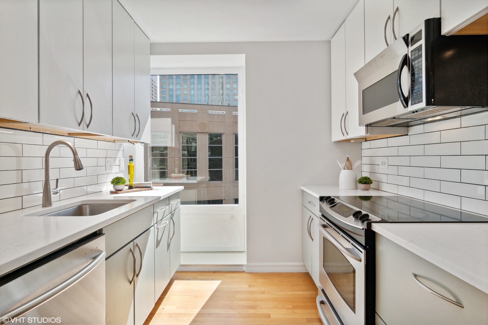 40 East Delaware Place, Unit 1602 Chicago, IL 60611 - Photo 8 of 27 a kitchen that has a sink and a stove