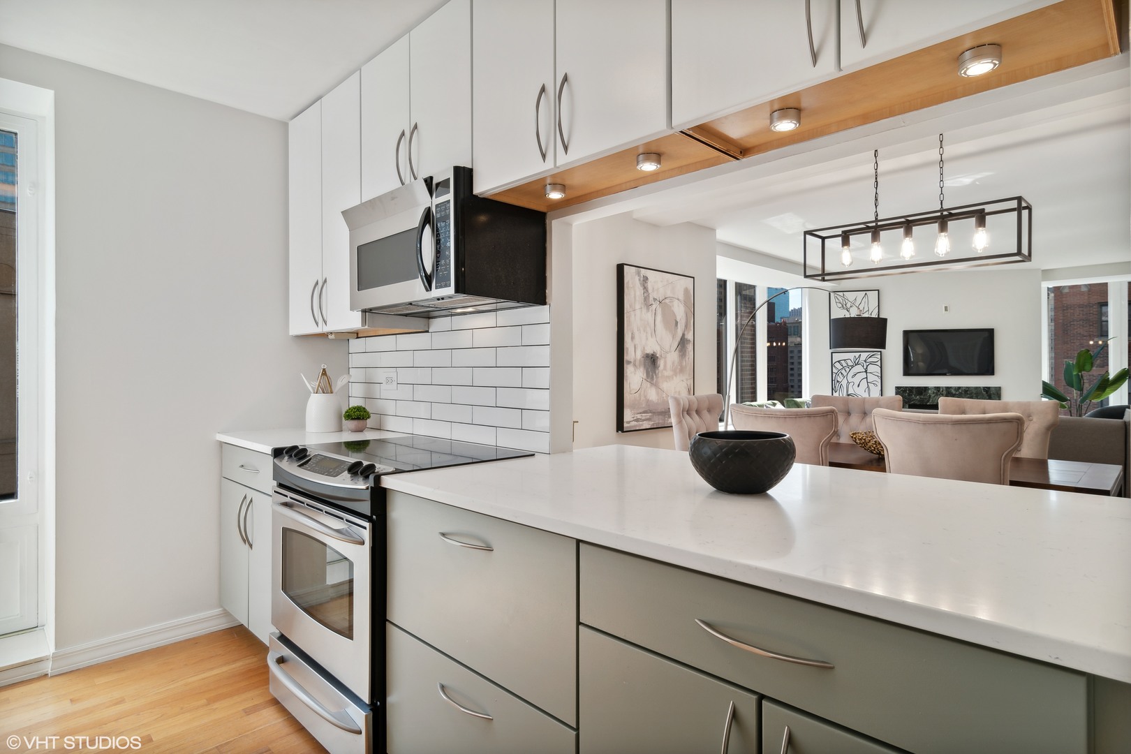 40 East Delaware Place, Unit 1602 Chicago, IL 60611 - Photo 9 of 27 a kitchen with stainless steel appliances a sink a stove and cabinets