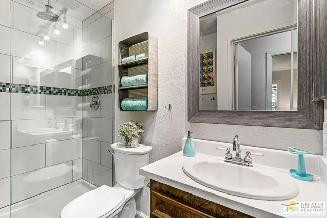 a bathroom with a sink toilet and shower