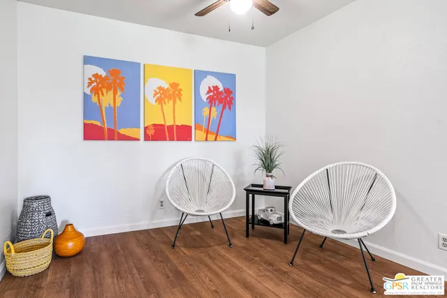 a view of a room with furniture and wooden floor