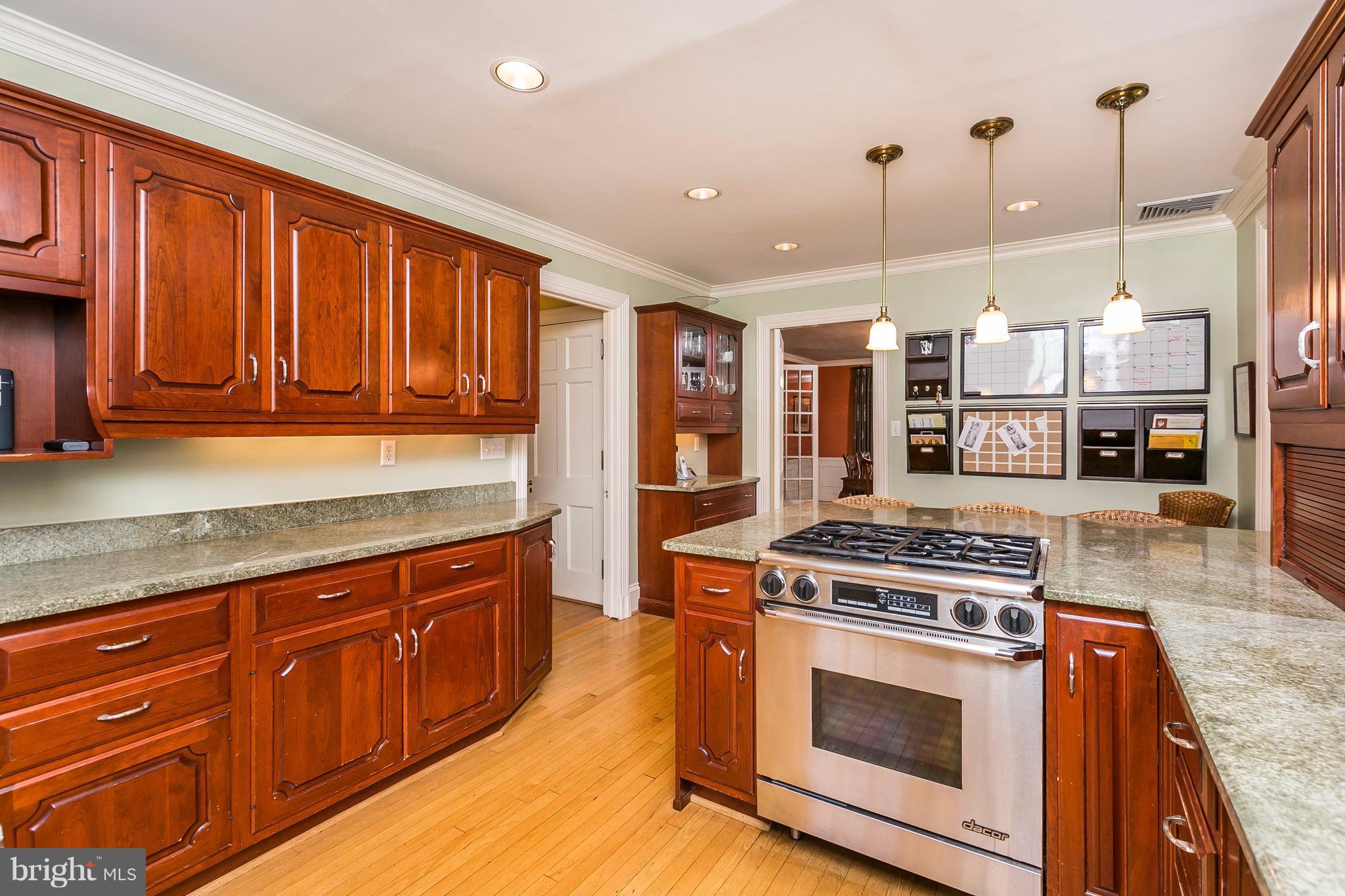 6306 Blenheim Road Baltimore, MD 21212 - Photo 13 of 30 a kitchen with stainless steel appliances granite countertop a stove a sink and a wooden floors
