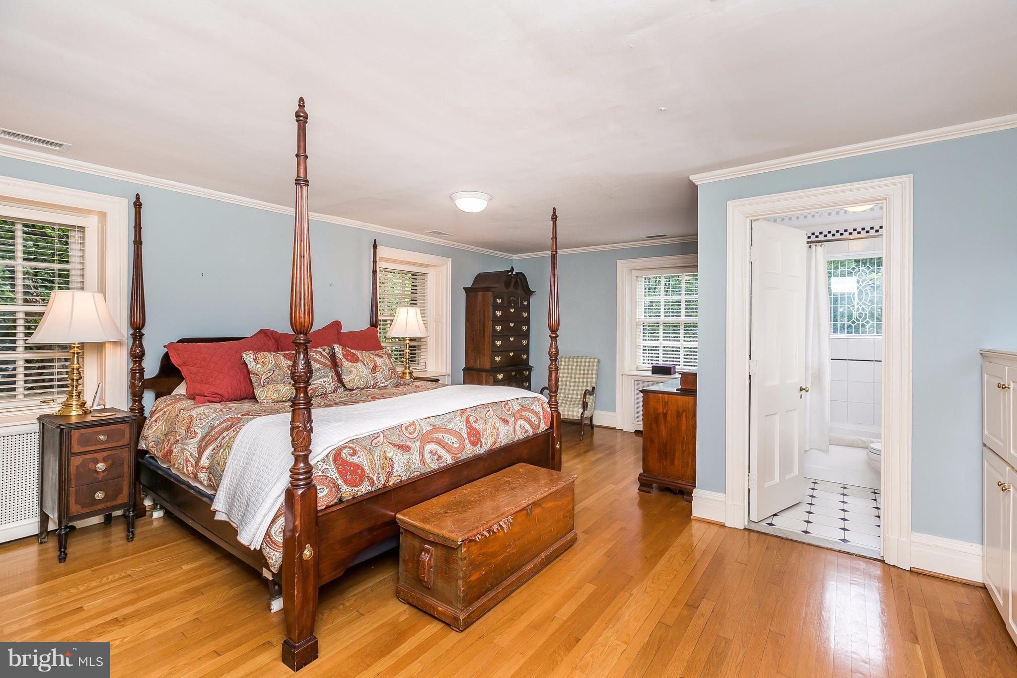 6306 Blenheim Road Baltimore, MD 21212 - Photo 16 of 30 a bedroom with a bed and wooden floor